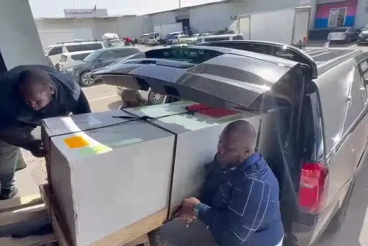 Perry's staff handling service-day transport logistics at a vehicle