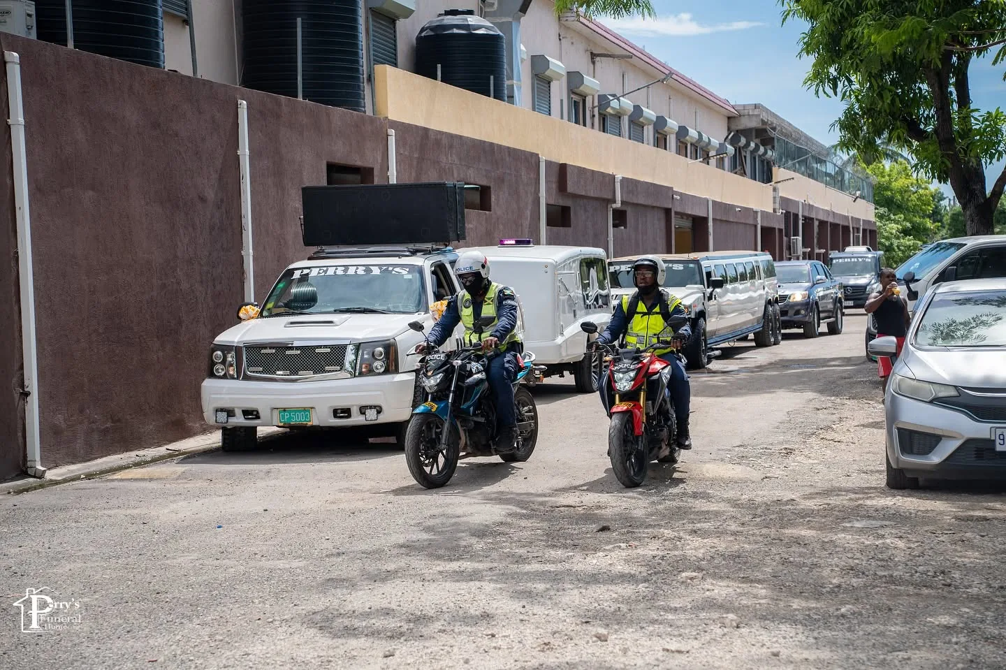Perry's funeral convoy lined up with motorcycle escorts and service vehicles