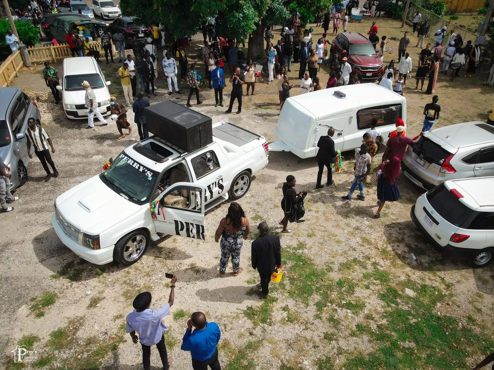 Aerial view of Perry's vehicles and guests during a large coordinated farewell