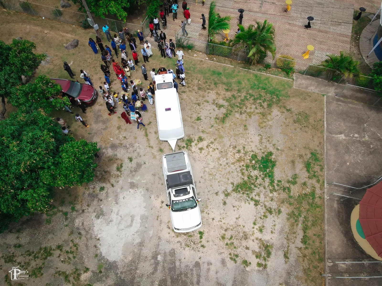 Aerial view of a Perry's funeral procession moving through a public gathering