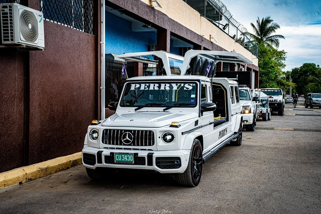 Perry's branded funeral vehicles prepared outside the facility