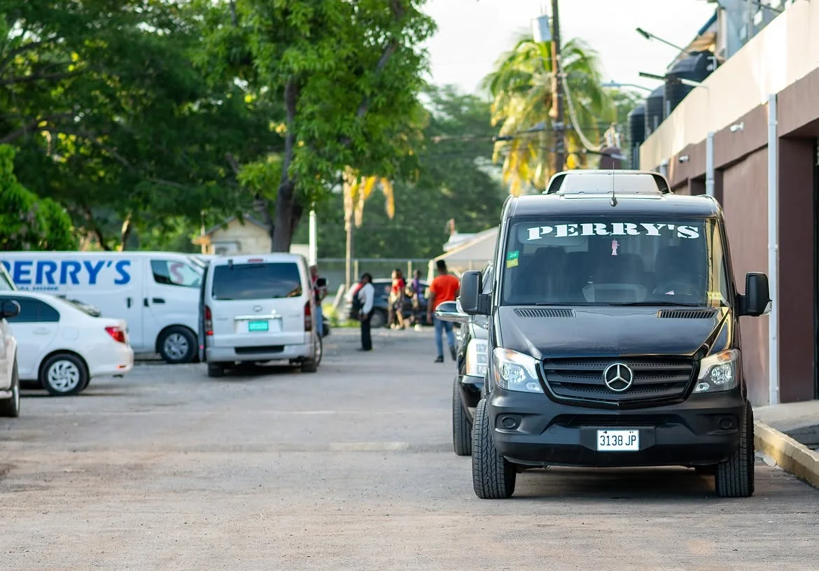Perry's branded funeral vehicles lined along Job Lane